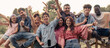 © Lomb - Happy friends and family celebrating together outdoors with raised arms