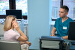 © Viacheslav Yakobchuk - Female patient sitting while doctor prepares to check an ear