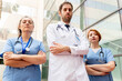 © StockMe - Healthcare team of doctor and nurses standing outdoors, expressing confidence and determination in healthcare and teamwork