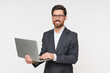 © InsideCreativeHouse - Busy business man using laptop standing isolated on white background. Male professional businessman ceo executive wearing suit holding computer working online checking corporate results.