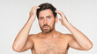 © InsideCreativeHouse - Beauty, hair and portrait of shirtless man in studio for grooming, personal hygiene or wellness. Face, shampoo and skincare with serious model isolated on white background for haircare treatment