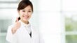 © PB Studio - illustration of an Asian nurse wearing a clean medical uniform, smiling warmly while giving a thumbs up gesture. The image is styled for stock use with soft lighting, a bright background, and