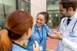 © StockMe - Healthcare professionals having a positive outdoor discussion, showing teamwork and shared success at a medical facility