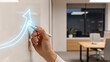 © Creative mind - A hand drawing a glowing upward arrow on a whiteboard in a modern office