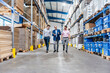 © Westend61 - Business management team walking in production hall warehouse