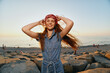 © SHOTPRIME STUDIO - lifestyle woman in modern boho-western denim street style smiling by the beach at sunset with film color warmth and relaxed mood