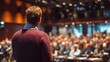 © LimeSky - Business forum with a speaker addressing attendees in a conference hall featuring an unknown individual viewed from behind