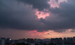 © Galeno - dramatic sky ominous dark clouds featuring vibrant pink highlights sunset set blurred urban