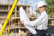 © BillionPhotos.com - confident male engineer  in helmet with a blueprint