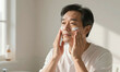 © Galeno - asian male shown waist carefully massaging facial moisturizer skin soft warm