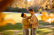© BGStock72 - A joyful moment shared between a Korean woman and a Caucasian man in a sunny autumn park