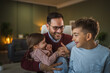 © Miljan Živković - Father holding happy daughter sharing family bonding moment