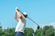 © buritora - Male golfer playing golf at a golf course (back view, tee shot, golf competition)