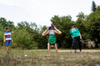 © Nikola Spasenoski - Family outdoors enjoying playful activity as a young girl performs a handstand