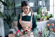 © Charlie's - Happy asian female florist Startup small business successful SME in flowers shop 