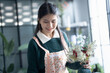 © Charlie's - Happy asian female florist Startup small business successful SME in flowers shop 