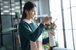 © Charlie's - Happy asian female florist Startup small business successful SME in flowers shop 