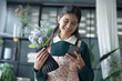 © Charlie's - Happy asian female florist Startup small business successful SME in flowers shop 