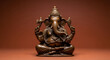 © BackgroundStudio - Bronze Ganesha statue seated on a pedestal against a warm brown
