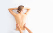 © Acronym - Young woman getting massaging treatment over white. Spa, healthcare and recreation concept.