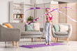 © Pixel-Shot - Cute girl with ribbon doing gymnastics at home