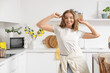 © Pixel-Shot - Beautiful young woman dancing in  kitchen