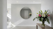 © Zahra - Minimalist hallway with large round mirror and floral decor.