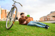 © Oscar - Courier taking a break on grass during city delivery
