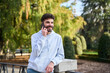 © Oscar - Young man enjoying phone conversation in city park