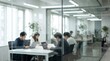 © CuteBee - Four dedicated professionals are attentively working on their laptops at a table within a bright, glass-walled modern meeting room, focused on collaborative tasks.