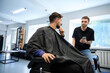 © Svitlana - Professional man listens hairstyle preferences during consultation