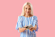 © Pixel-Shot - Mature woman with dollar banknotes on pink background
