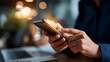 © Kateryna - Hand holding mobile phone checking notifications alert person reviewing smartphone for work or messages device interaction with notification checking shown home or office
