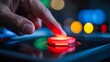 © kobir - Close-up of a finger pressing a red button on a touch screen interface