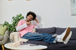 © LIGHTFIELD STUDIOS - Casual day indoors enjoying a cup of coffee in a cozy modern living room