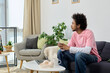 © LIGHTFIELD STUDIOS - Young handsome man relaxing at home in cozy living room setting