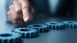 © TensorSpark - Hand adjusting metal gear on table representing change management transformation, strategy alignment, process optimization and leadership intervention.