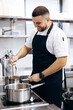 © Petro - Chef preparing fresh soup at the restaurant kitchen