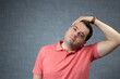 © AnaRosa - Casually dressed adult man tilting his head sideways to stretch his neck. Ideal for wellness content, physiotherapy, posture correction, pain relief, and healthy lifestyle campaigns.