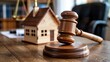 © Design Stock - Gavel and miniature house on wooden table representing property law, real estate issues, legal authority, and justice in housing matters