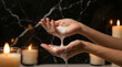 © DimaSabaka - Woman washing hands with white soap foam against dark marble background with candles