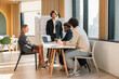 © chokniti - Business Presentation of Marketing Plan and Data Analysis in Modern Office, Young Professional Presenting Strategy, KPI Metrics and Project Workflow to Team During Corporate Meeting