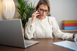 © Nenad - Mature businesswoman beautiful charming smiling and talking on the mobile phone in the office.