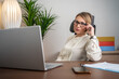 © Nenad - Confident businesswoman smiling while working in a bright office environment