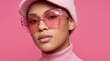 © Shamshad - Stylish young woman wearing oversized pink sunglasses and matching knit beanie against vibrant background