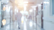 © Eireen - Medical concept background with blurred silhouette of doctor walking in bright hospital corridor with bokeh light effect