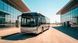 © kaleidoscope - A bus waits in front of airport terminals under clear blue skies. Passengers may board for flights nearby