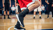 © Saieem - Basketball player's legs wearing weighted ankle cuffs during a drill on a wooden court.