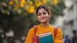 © Babb - Young asian female student with books smiling outdoors in autumn