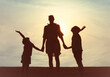 © kieferpix - Mother and Children Silhouette at Sunset Holding Hands